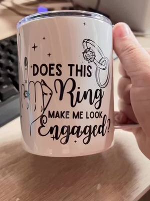 A post by @namelessboutique on TikTok caption: Ignore my messy desk. Congrats to my cousin and her engagement. #enganged #mug #cute #ring