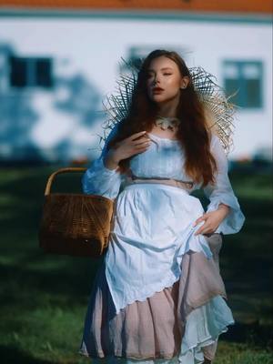 A post by @a_girskaya on TikTok caption: A gaze that tells a thousand tales, as timeless as the countryside breeze.  #RedheadRevolution #FashionThrowback #CountrysideFashion #EleganceInSimplicity #TimeTraveller #GingerModel #OldSoulNewWorld #PortraitPerfection #GingerPride #StyleRewind #RusticFashionista #NaturalBeauty