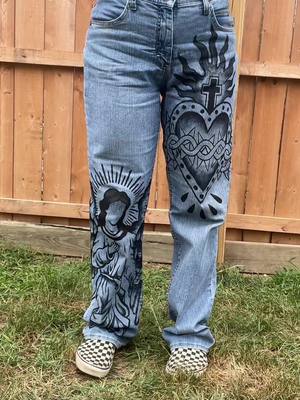 A post by @hooliet13 on TikTok caption: these might be my fave thing ive ever made #art #arttok #fashion #customfashion #custom #paint #jeans #tattoo #customjeans #fashiontok  