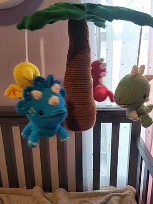 A post by @frogtales7 on TikTok caption: Dinosaur Baby Mobile  #Crochet #CrochetersofTikTok #Dinosaurs #BabyMobile #HandMade #MadeWithLove #Crafter #CraftersofTikTok #fyp #fypppppppppp #fyp #foryoupage #Crocheted #Dinosaur #BabyRoom #BabyDecor #OneOfAKind