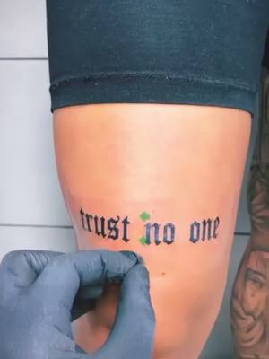 A post by @efternamnnamn on TikTok caption: TRUST NO ONE💀 #tattoo #legtattoo #trustnoone #fyp 