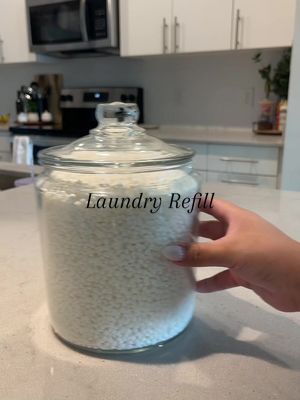 A post by @izzzbeth on TikTok caption: Laundry refill day #laundry #laundrytok #asmr #satisfying #refill 