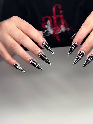 A post by @nailzdidbycoco on TikTok caption: Giving NUN 🤩 #stilletonails #gelxnails #apresgelx #fyp #halloweennails #nunnails #blacknails 