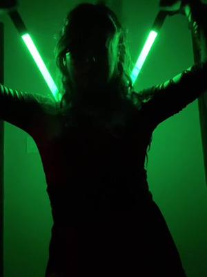 A post by @palomadameron on TikTok caption: Missing my girl Azirah 💚 #nightsister #oc #starwars #nightsistercosplay #lightsaber #throwback