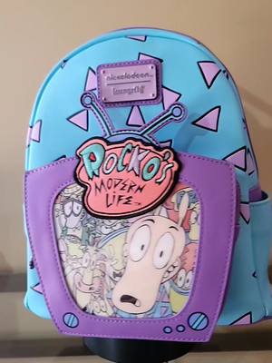 A post by @frogtales7 on TikTok caption: Rocko's Modern Life..brings back childhood memories💜🩵💜🩵 #RockosModernLife #90sCartoons #RetroCartoon #Loungefly #MiniBackpack #LoungeflyMiniBackPack #LoungeflyCollection #NewCollector #Collection #Loungefly #fypppppppppp #foryoupage #fyp