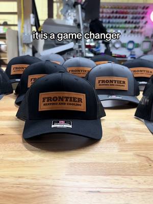 A post by @thecoffiecutters on TikTok caption: We offer a bulk pricing & can source almost any hat brand! Send us a message to get your order started today 🧢 #branding #promotionalproducts #marketingtips #leatherpatchhats #SmallBusiness #etsyseller 