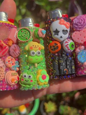 A post by @ayy_foo on TikTok caption: lighter sleeves i made so far. 💖💚🖤 #fyp #foryou #foryoupage #sanrio #hellokitty #keroppi #pompompurin #lighter #lighters #rhinestones #bedazzled #SmallBusiness #trending #spooky #halloween #spookyseason #pink #glitter