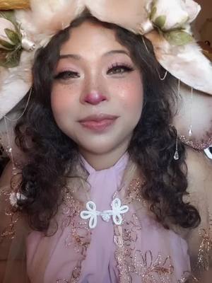 A post by @snugglebunny626 on TikTok caption: Tatiana has a little message for you 🐰🌸💗💫 #tatianalagomorpha #queentatianalagomorpha #thebunnyfolkqueen #bunnyoc #bunnyocc #bunnyoccosplay #rabbitoc #rabbitocc #rabbitoccosplay #bunnyfolk #bunnyfolkoc #bunnyfolkoccosplay #rabbitfolk #rabbitfolkoc #originalcharacter #originalbunnycharacter #bunnyfolkcosplay #bunnyfolkcosplayer #thebunnyfolkcosplayer #fae #faefolk #faeworld #faewild #bunnyburrow #thebunnyburrow #bunnyburrowcharacters #bunnyburrowresidents #fantasy #fantasyworld #whimsical #whimsicalcharacters #dnd #dndtok #dndfam  #latinxcreator #latinxcosplayer #cosplayer #cosplaytok #poccosplayer #pocfantasy #pocfantasytok #pocfantasycharacters #fyp #foryou