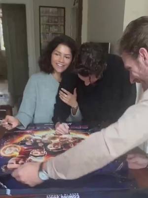 A post by @tomhollandsdaya on TikTok caption: They’re so cute 🥹🫶🏻 Z was competing with Tom about who could sign the posters the fastest lmao! She said “and I’m winning” and then she said “waiting for youuu” 🤍 #Zendaya #TomHolland #Tomdaya #spidermannowayhome 