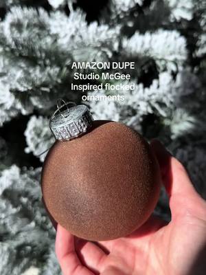 A post by @alaniestelle on TikTok caption: These are so close to the og ones😍 on my storefront under ‘Christmas decor’ 🤍 #studiomcgee #flockedornaments #christmastreedecorating #velvetbows #amazonfinds #amazonchristmas #blackfridaysale