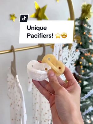 A post by @milksnob on TikTok caption: Our shimmer collection includes our pearl and golden pacifiers and matching pacifier clips! They are the perfect addition and gift for your little ones this holiday season! ⭐️🎁🎄 #giftidea #pacifiers #unique #uniquegifts #giftideas