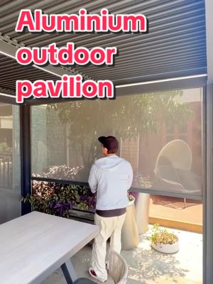 A post by @tangmeng6 on TikTok caption: Aluminum alloy outdoor pavilion. #pavilion #gardenproject #garden #gardentok #outdoorroom #balconygarden #rollershutter #rollershutters #rollershutterdoor