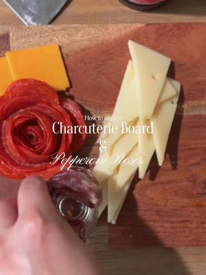 A post by @theitmom on TikTok caption: I made my first charcuterie board, friends! It was a lot easier than I thought, as long as you have all the ingredients and have your idea planned out ahead of time. I got a long charcuterie board (this one is a 36” @crateandbarrel Cheeseboard, but you can also buy similar ones on Amazon)! @Campo Grande Meats also gifted us some yummy Iberico Pork (known as the wagyu of pork) delivered! They’re on a mission to deliver the best of Spain’s delicious food culture straight to your doorstep! Next you’ll want to gather all of your ingredients you’ll be using to construct your board. The trick is using the rule of 3’s (or 3-3-3-3) for an ideal aesthetic. This means that every charcuterie board should have: • 3 different types of meats • 3 different types of cheeses • 3 different types of crackers • 3 different starch options such as fruit, nuts, veggies I’m using 3 different cheeses, gourmet crackers, raspberry jam, grapes, and rosemary garnish that I bought at Amazon Fresh for less than $21! I was really pleased with their quality selection and low prices, I had never bought groceries or food at @Amazon Fresh  And also learned this super easy design hack from my MIL on how to create pepperoni or salami roses: Use a small glass with a small opening (I used a shot glass or you can use a wine glass if you have lots of slices). At the top of the glass, place slices of meat on the edge and fold over in half. Layer the next piece overlapping the previous piece and continue all the way around the glass using several layers. Next, turn the glass upside down and firmly press onto your board or tray, and twist it slightly to release the glass from the meat. For the cheeses —  I cut square pieces into triangular slices or thin rectangular slices and made different designs throughout my board.  To add that touch of elegance to the look, I added a solid cheese wedge. It was a huge hit at the party! Be sure to like and save this post for more hosting and home decor tips and tricks! #charcuterie #charcuterieboard #cheeseboard #meatandcheeseboard #hosting #partyinspiration #partyhost #partytips #charcuterieboards #charcuterieplatter #makefoodwithme 