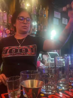 A post by @abbyjo.33 on TikTok caption: On mondays we show off our pours 😂 don’t mind my double chin or serious face 😐 #bartender #thedive #doublechin #momswhobartend #girlswithtattoos #tool #divebar #girlswhobartend 