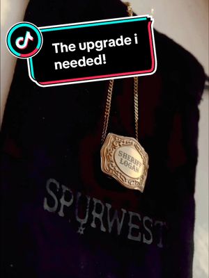 A post by @outlawequestrian on TikTok caption: Everybodies a Cowgirl but theres only one Sheriff. @SpurWest Custom Mini Belt Buckle Necklace.  #fypシ #wildwest #rodeotok #spurwest #ranchlife #ranch #ranchtok #western #westernfashion #westernwear #westernstyle #horsegirl #equestriantok #horsetok #cowgirl #cowboy #yeehaw #westernriding #westernhorse #westernhorsesmerch 