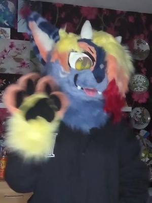 A post by @bunnybunaki on TikTok caption: they don't really get along 🤣 #kemonofursuit #furryfandom #furrytiktok #furry #dinomask 