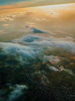 A post by @phil2gold on TikTok caption: up in the sky. germany from above 🦅 #sky #flying #flight #clouds #heaven #germany #beautiful #sunset 