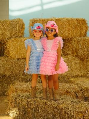 A post by @monnalisa_official on TikTok caption: Saddle up for a country adventure with two adorable cowgirls!  🤠👗  #Monnalisa #ItalianFashion #SS24 #Kidswear