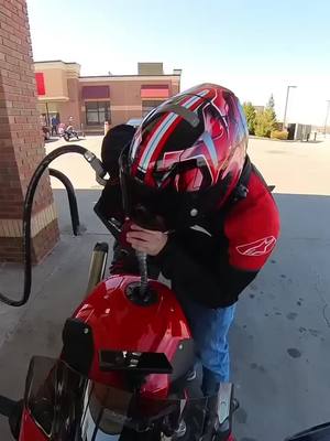 A post by @twodogs_moto on TikTok caption: can't even pump my damn gas in peace without being violated by @TJ 🤣🤣🫶 #bmw #bmwmotorsport #fyp #shoei #s1000rr #foryou #alpinestars #shenaningans #gasstation #caseys #violated #foryoupage 