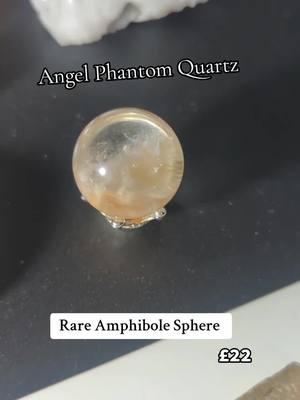 A post by @hq.aka.hollie on TikTok caption: Angel phantom Quartz #phantomquartz #rarecrystals #sphere #amphilbole 