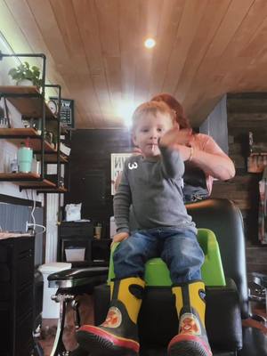 A post by @schromama on TikTok caption: My little side kicks turn for a hair cut.  #femalebarber #mamabarber 