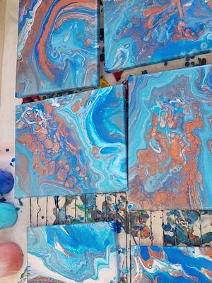 A post by @julieb603 on TikTok caption: This set of 6 8x10 canvases are freshly poured and still wet!  #FluidArt  #AcrylicPouring  #PourPainting  #FluidPainting  #PourArt  #FluidPouring  #AbstractArt  #FluidAcrylic  #ArtPour  #ArtisticPour  #dirtypour  #abstractart  #viralart  #pouryourheartout  #oceanvibes 