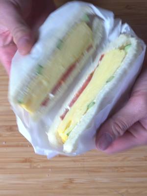 A post by @truongsauce on TikTok caption: Airplanes or trains? #tamagoyaki #sandwich #food #Recipe * 3 eggs * 3 tbsp water * 2 tsp sugar * pinch of salt * pinch of dashi powder * silced cucumber * sliced tomato * kewpie mayo 1. In a mixing bowl add your eggs, wataer, sugar, salt, and dashi powder, whisk them all together 2. Strain your mixture 3. Then using an oiled tamago yaki pan on medium low heat add about a 1/2cm to 1cm layer of egg, you should hear it lightly sizzle 4. after shaking the egg around a bit the consistency should be around a honey or syrup that when you want to roll it up. the bottom should be solid and the top should be a little runny still 5. once you roll it towards you, carefully and gently push the roll away so you can pour on the next layer. Gently lift the previous roll so the new egg can stick to the bottom and repeat the steps until you get a roll of your desired texture 6. If your roll ends up to skinny or weird shape, you can just slice them into equal thickness and put them sliced side up to make your sandos, no need to get the perfect roll 7. On shokupan add your mayo, layer on your cucumber, tamago yaki, and tomato. lightly salt your tomato and top with with other piece of bread 8. Wrap with parchment paper or plastic wrap (chill for better results and easier slicing) and then cut for a nicer cross section