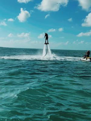 A post by @captain_braxton_black on TikTok caption: First time trying the fly board! #flyboard #jetski #watersports