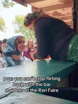 A post by @hailierosie on TikTok caption: She hopped onto the counter to deliver the beverage ~personally~, what else is a jester to do but flirt back immediately? #renfaire #renaissancefestival 