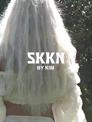 A post by @kimkardashian on TikTok caption: Meet your new @SKKN BY KIM summer essentials: a sheer, cushiony Lip Gloss that builds color and shine with every swipe and a light-catching, buildable Highlighter with an effortlessly luminous finish 💋✨ Arriving on June 21st at 9AM PST. Join the waitlist at SKKNBYKIM.com