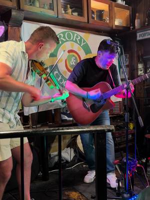 A post by @seanmageemusic on TikTok caption: Trad Set with Rory Gallagher onstage in Lanzarote, @irishvikinglanzarote🎻 @travelon.world  @ptodelcarmen  #Lanzarote #puertodelcarmen #fiddle #irishmusic #pints