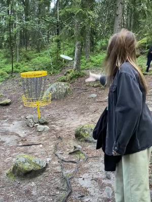 A post by @juliapiires on TikTok caption: who would have thought that in 2024 I'd be in the Swedish forest learning disc golf 🥏 #discgolf #swedish #sweden #forest 