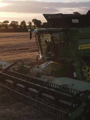 A post by @agriview on TikTok caption: 🤯 JOHN DEERE X9 in sunset harvest 🌞 . . . #harvest #x9 #johndeere #agriculture #sunset #bigfarm #farming #farm #moisson 