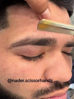 A post by @nader.scissorhandz on TikTok caption: #chicagobarber #chicago #brows #eyebrows #haircut #lineup #foryou #share #beard #barbershop #barbershop #fyp #shave 