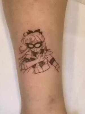 A post by @massielnh on TikTok caption: my favorite Tat artist, caro, at Cake is a lie shop wiped up the fun #sailorv tat ! 🤩🤩 #sailormoon #tattootiktok #ny 