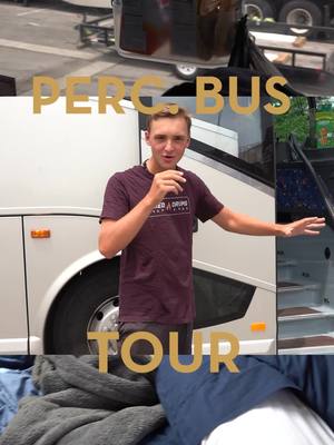 A post by @carolinacrown_official on TikTok caption: Perc. Bus Tour 🚍 Come along with Brenden, CrownBattery Memeber, as he takes us on a tour of their bus. Check out what movies they watch and the hidden jems!   • What are some bus movies you love to watch?!  Let us know!  #DCI #CarolinaCrown #crownpercussion 