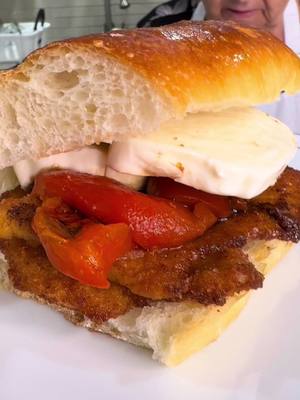 A post by @nonnapiaa on TikTok caption: Nonna Pia makes a Mouthwatering Chicken Cutlet Sandwich🐔 🥪👵❤️ #nonnapia #chickencutlet #sandwich #MadeWithLove #oldschoolitalian #homecooking 