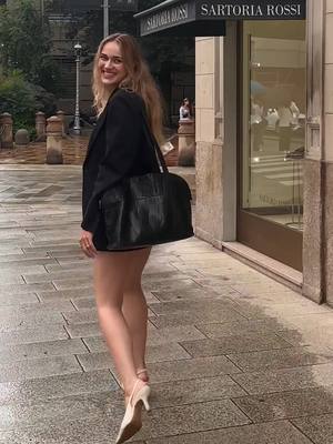 A post by @kathrineholmsgaard on TikTok caption: Just a girlie in the rainy streets of milan  #outfitinspo #feminineenergy #fashion 