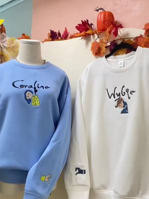 A post by @boo.hal on TikTok caption: Unlock Coraline’s twisted tale every time you wear these sweatshirt 🎃 #coraline #coralinejones #coralinemovie #wybie #otherfather #othermother #halloween #spookyseason #matchingoutfits #matchingsweatshirts #coupleoutfit #couplesweatshirt #embroideredhoodie #embroideredsweatshirts #embroiderysmallbusiness #boohaul 