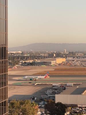 A post by @rustn_away on TikTok caption: Watching airplanes never gets old! #lax #hiltonlax #hilton @JetBlue 