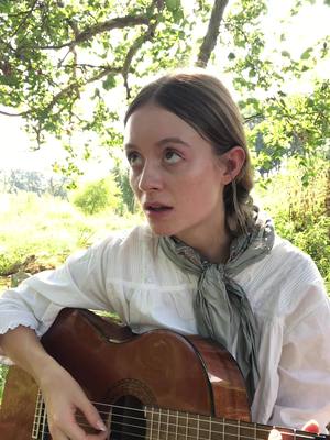 A post by @gabriellehopemusic on TikTok caption: tiny bugs - by me!!! #folk #mountains #singer #banjo #country 