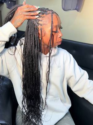 A post by @enyahalexandra on TikTok caption: Very neat, very small , very  much cutsey : small knotless + boho + waist + wavy ends ✨ #atl #atlbraider #atlhairstylist 