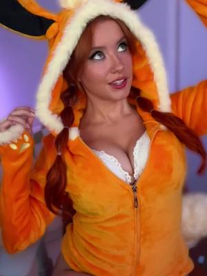 A post by @thousandhunny on TikTok caption: How much of a Furry am I in this outfit? 🐾🧡🔥 #eevee #eeveelution #flareon #pokemon #pokemoncards #redhead #redhair #ginger #anime #animegirl #cosplayer #cosplay #namiswan #onepiece #mommy #GamerGirl #gamer #streamer #uwugirl #thousandhunny #hunnyandditto #CapCut #audio  