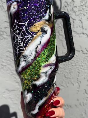 A post by @terriestumblers on TikTok caption: Swirly glitter marble halloween style: Tumbler on sale right now #halloweencolors #glitterswirl #stanleydupe #halloweencups 