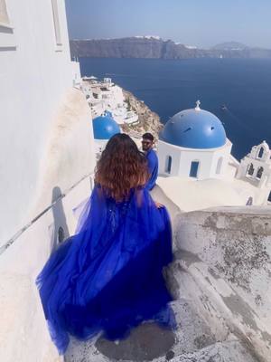 A post by @_mouuuuse_ on TikTok caption: Strolling through a dream, where the blue domes meet the endless sky💙🤍 @Pranto  . .  . #santorini #bluedomes #couplegoals #husbandwife #bengali #bdtiktokofficial #tiktokbd #bd #bangali #greece #blue #white #ocean #foryou #parisbd #BeautyTok #brown #oiasantorini #dresses #poses #browncouple #desi #desitok #desitiktok #arijitsingh #hindisong #india #bangladesh #desh 