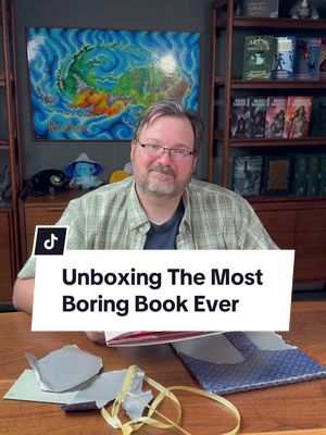 A post by @authorbrandonsanderson on TikTok caption: The Most Boring Unboxing Ever… Boring fact about me—my favorite drink is water.  Special thanks to my publishers @Macmillan Children’s Books @Macmillan  #BrandonSanderson #unboxing #TheMostBoringBookEver 