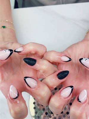 A post by @bmills123 on TikTok caption: 👻🕷️🕸️🤍🖤  #nails #nailtrends 