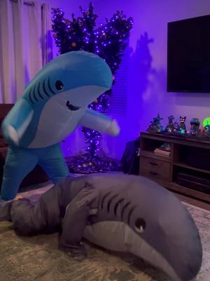 A post by @what_duh_tok on TikTok caption: Can Mommy and Daddy Shark keep up with #dancingwiththestars ? Couples challenges get more complicated in shark suits. Try it out for yourselves, link to inflatable shark suit in my showcase. Watch the whole video for outtakes #mamashark #dwts #landshark #ad 