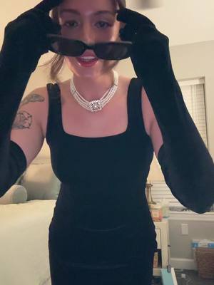 A post by @gigibean9 on TikTok caption: suddenly youre afriad and you dont know what youre afraid of🖤 #fyp #foryou #breakfastattiffanys #halloweencostume #halloweenlook #audreyhepburn #halloweekend #party #hollygolightly #cat 