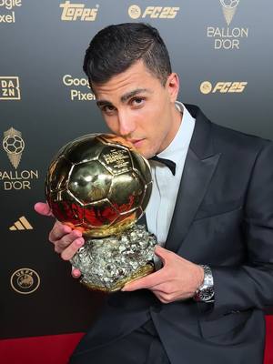 A post by @ballondor on TikTok caption: Rodri kisses his first Ballon d’Or ✨ #ballondor #sportstiktok #football 